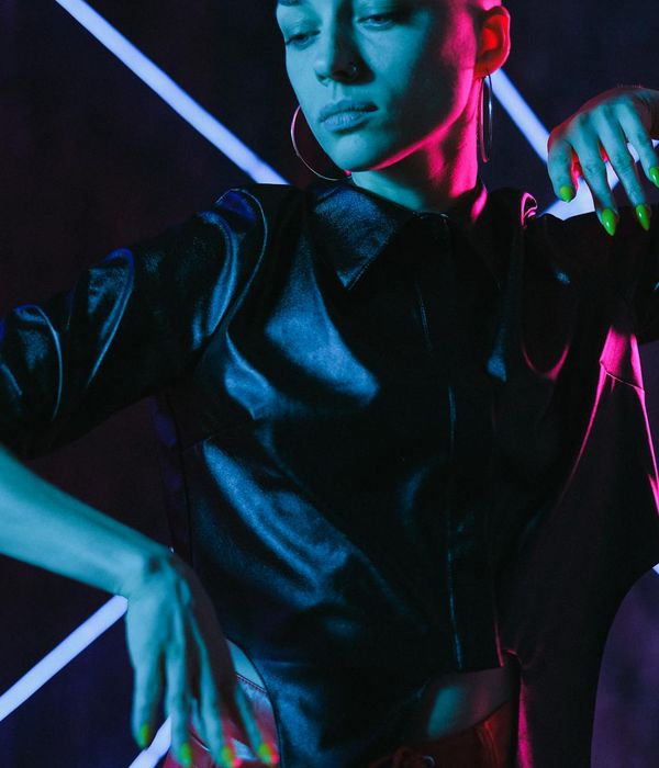 Woman performing a dynamic cardio move in a modern studio.